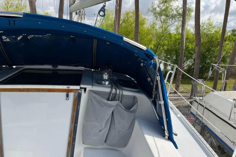 Slide: The Image of Cockpit of a 1999 Catalina 36 MkII sailboat with blue canopy and storage pockets. - 3