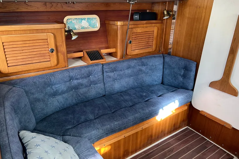 Slide: The Image of Interior of a 1999 Catalina 36 MkII sailboat with blue cushioned seating. - 5