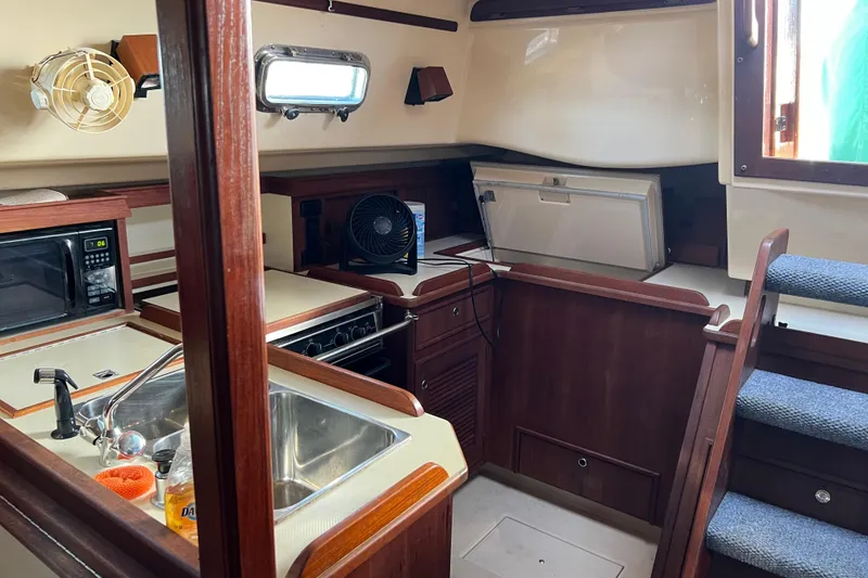 Slide: The Image of Interior of 1999 Catalina 36 MkII sailboat featuring kitchen area with sink and microwave. - 6