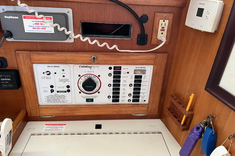 Slide: The Image of Control panel of a 1999 Catalina 36 MkII yacht with electrical switches and outlets. - 8