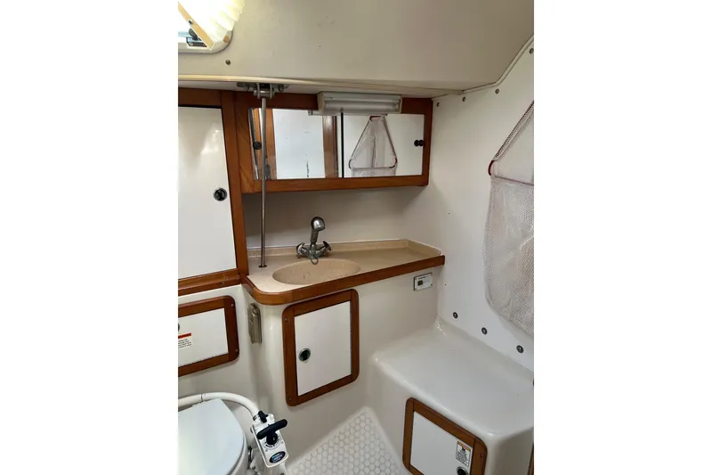 Slide: The Image of Bathroom interior of 1999 Catalina 36 MkII sailboat with sink and storage cabinets. - 9