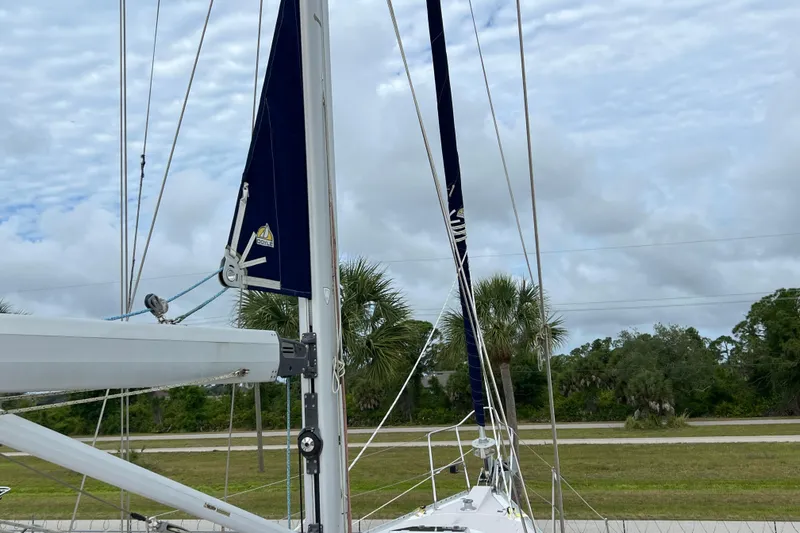 Slide: The Image of Sailboat mast and rigging of 2008 Catalina 470 against cloudy sky and palm trees. - 14