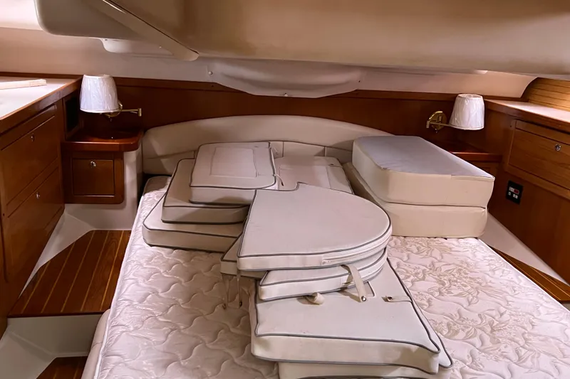 Slide: The Image of Interior cabin of a 2008 Catalina 470 yacht with cushions and wooden cabinetry. - 17