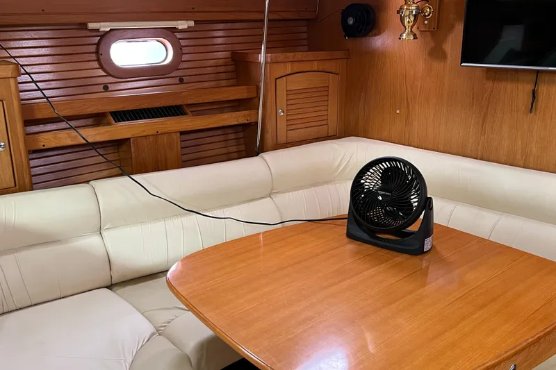 Slide: The Image of Cozy interior of 2008 Catalina 470 yacht with fan on wooden table. - 20