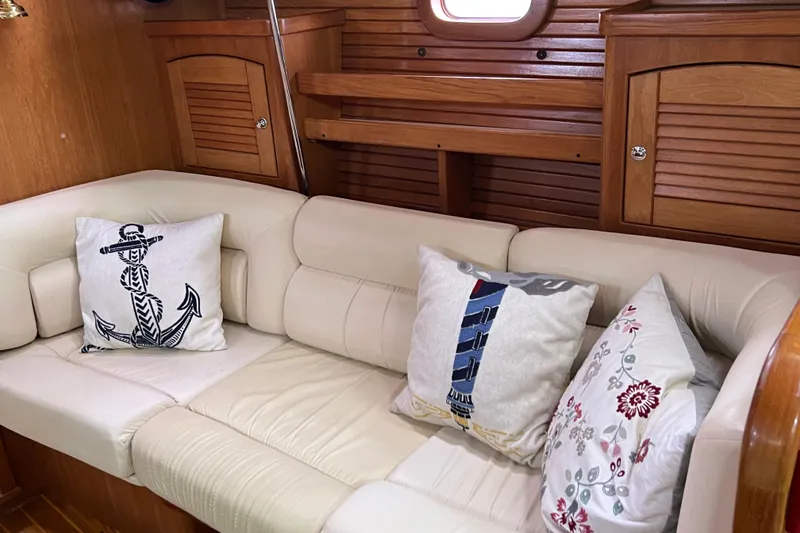 Slide: The Image of Interior of 2008 Catalina 470 yacht with cozy cushions and wooden cabinetry. - 22