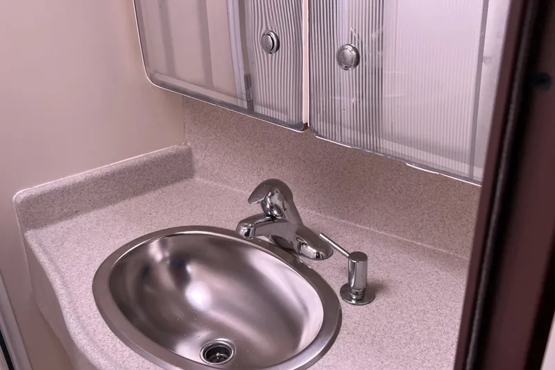 Slide: The Image of Compact bathroom sink with chrome faucet in 2008 Catalina 470 yacht. - 23
