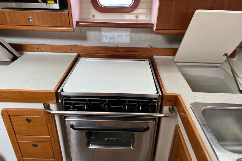 Slide: The Image of Galley kitchen in 2008 Catalina 470 yacht with stove and sink. - 27