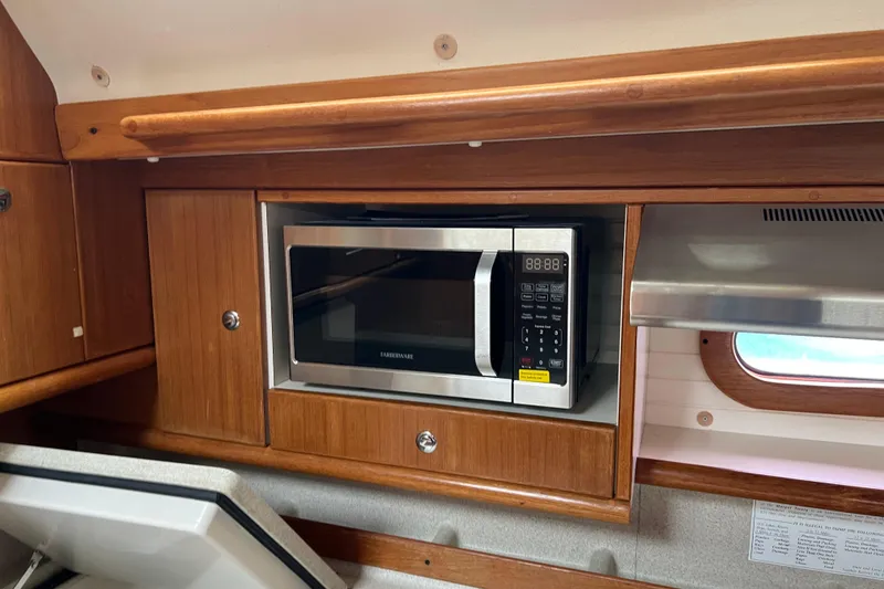Slide: The Image of Microwave in 2008 Catalina 470 yacht kitchen with wooden cabinetry. - 28