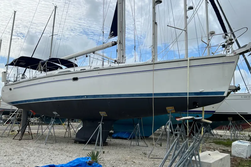 Slide: The Image of Sailboat Catalina 470, 2008 model, on stands in a boatyard under cloudy skies. - 7