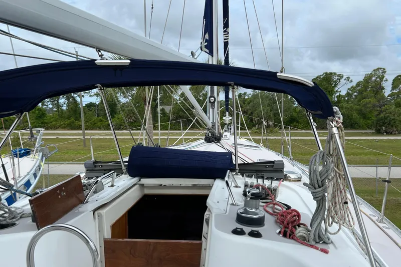 Slide: The Image of 2008 Catalina 470 sailboat deck with ropes and canopy, docked outdoors. - 8