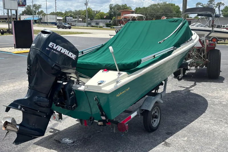 Slide: The Image of Vintage 1966 Mohawk 15 boat with Evinrude motor, green cover, on trailer. - 11