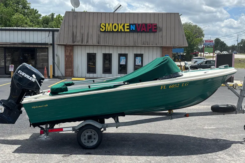 Slide: The Image of 1966 Mohawk 15 boat on trailer outside Smoke N Vape shop. - 12