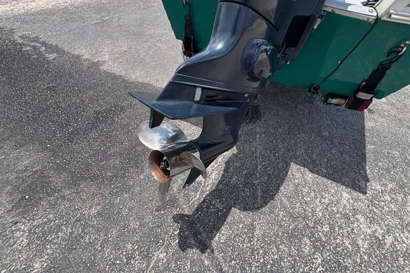 Slide: The Image of Outboard motor propeller of a 1966 Mohawk 15 boat on asphalt surface. - 18