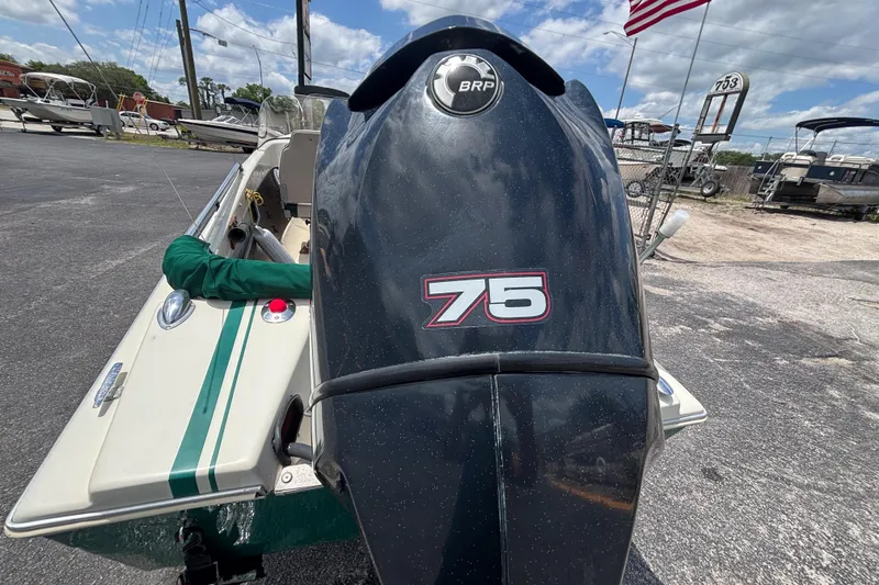 Slide: The Image of 1966 Mohawk 15 boat with BRP 75 outboard motor, parked outdoors. - 19