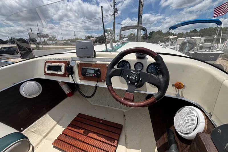 Slide: The Image of 1966 Mohawk 15 boat dashboard with steering wheel, gauges, and Garmin device. - 26