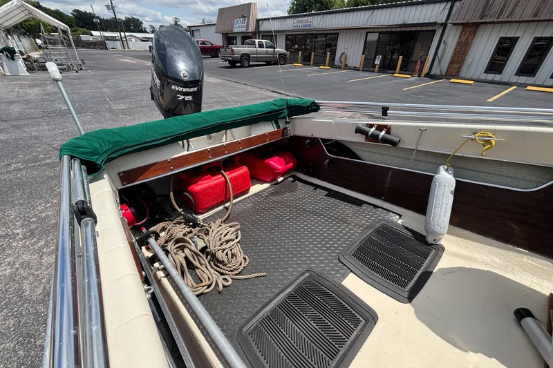 Slide: The Image of 1966 Mohawk 15 boat interior with Evinrude motor, ropes, and fuel tanks. - 27