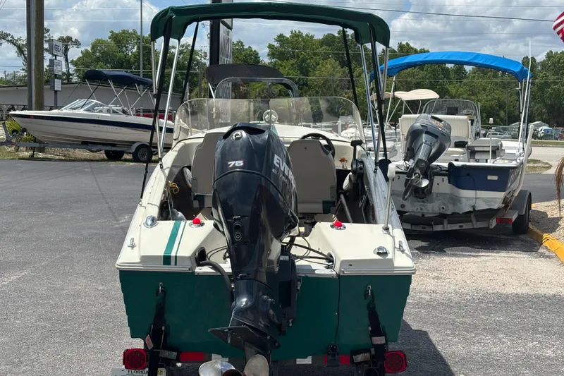 Slide: The Image of 1966 Mohawk 15 boat with Evinrude 75 engine, parked outdoors on a sunny day. - 5