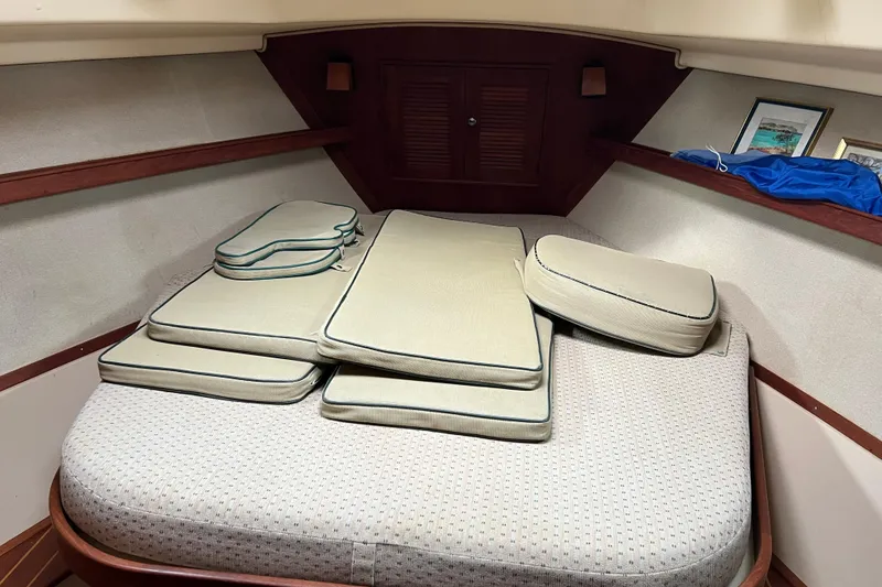 Slide: The Image of Forward stateroom of 2002 Island Packet 380 sailboat. Also shown are cockpit cushions - 14