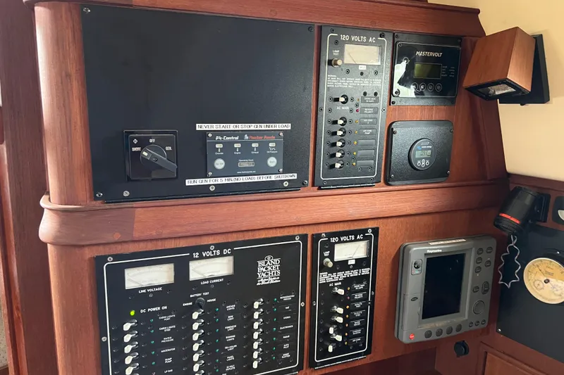 Slide: The Image of Control panel of a 2002 Island Packet 380 yacht, featuring electrical and navigation systems. - 9