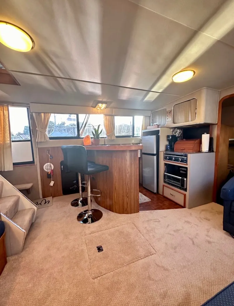 Slide: The Image of Interior of 1988 Chris-Craft 381 Catalina yacht with kitchen and bar stools. - 15