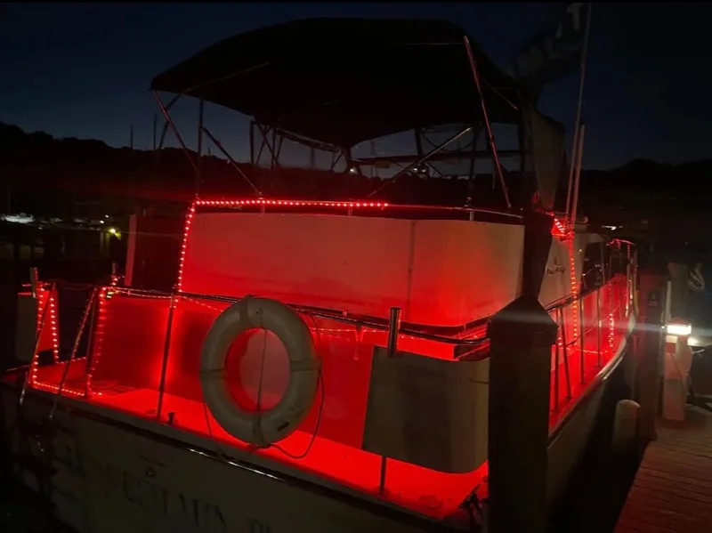 Slide: The Image of 1988 Chris-Craft 381 Catalina with red lights at night. - 16