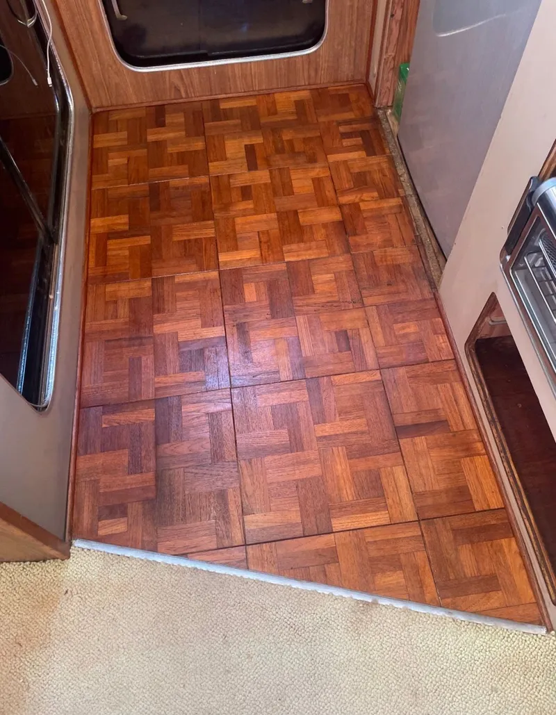 Slide: The Image of Wood flooring inside a 1988 Chris-Craft 381 Catalina boat. - 17