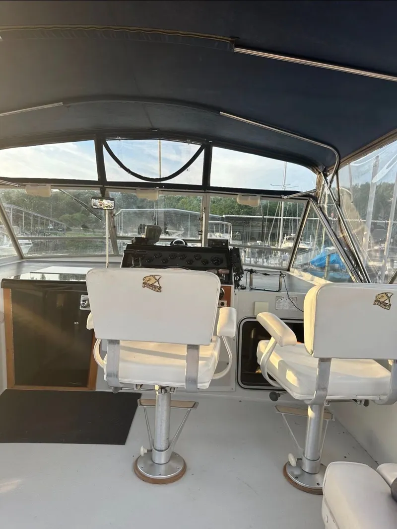 Slide: The Image of Interior of a 1988 Chris-Craft 381 Catalina boat with white seats. - 3