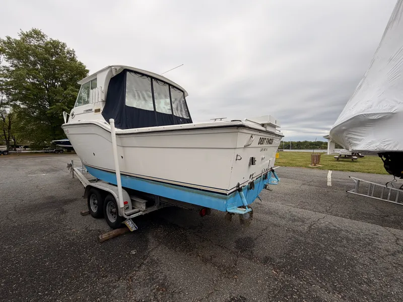 Slide: The Image of 2000 Baha Cruisers 272 Fisherman on trailer parked outdoors. - 6