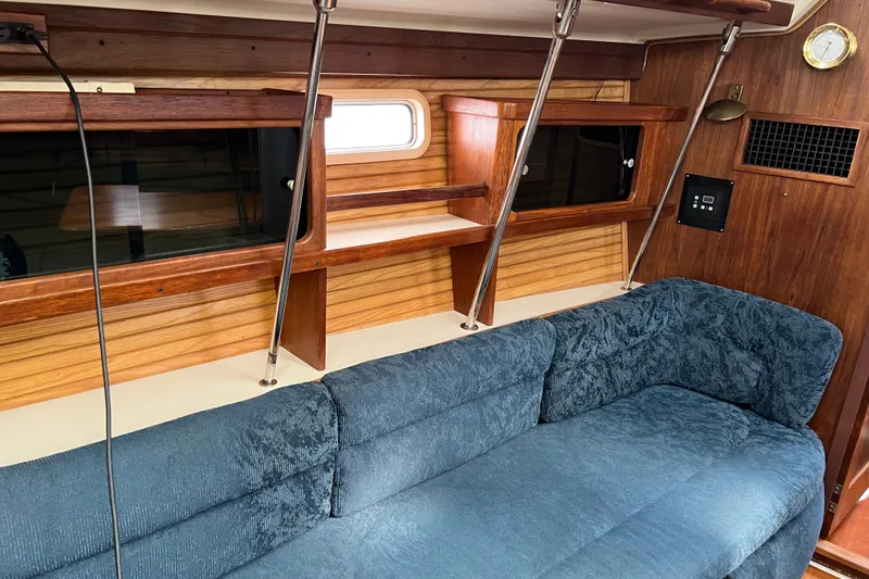 Slide: The Image of Interior of a 1997 Catalina 400 sailboat with blue upholstery and wooden accents. - 10