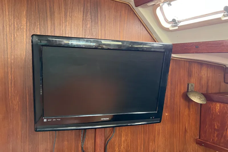Slide: The Image of Flat-screen TV mounted on wooden interior of 1997 Catalina 400 sailboat. - 16