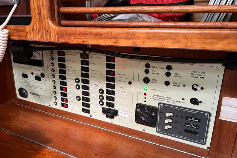 Slide: The Image of Control panel of a 1997 Catalina 400 yacht, featuring various switches and indicators. - 17