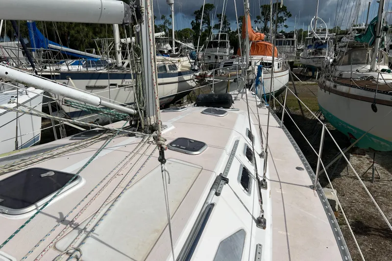 Slide: The Image of 1997 Catalina 400 sailboat on land, surrounded by other boats in a marina. - 2