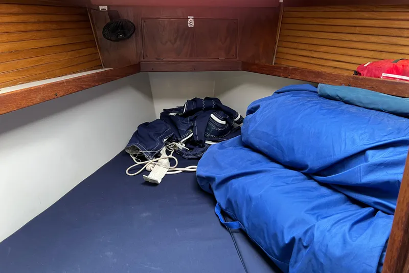 Slide: The Image of Cozy cabin interior of a 1997 Catalina 400 sailboat with blue bedding and nautical gear. - 21