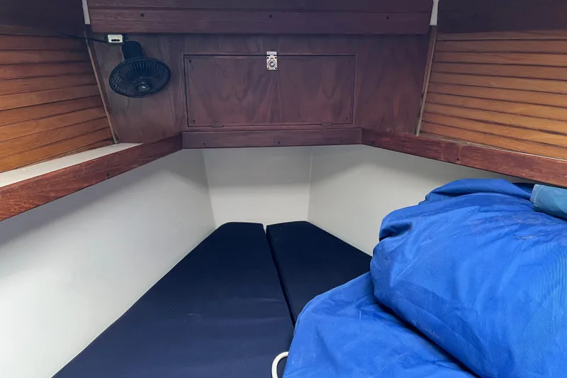 Slide: The Image of Cozy cabin interior of a 1997 Catalina 400 sailboat with blue bedding. - 22