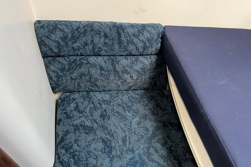 Slide: The Image of Blue upholstered seating in a 1997 Catalina 400 boat interior. - 23