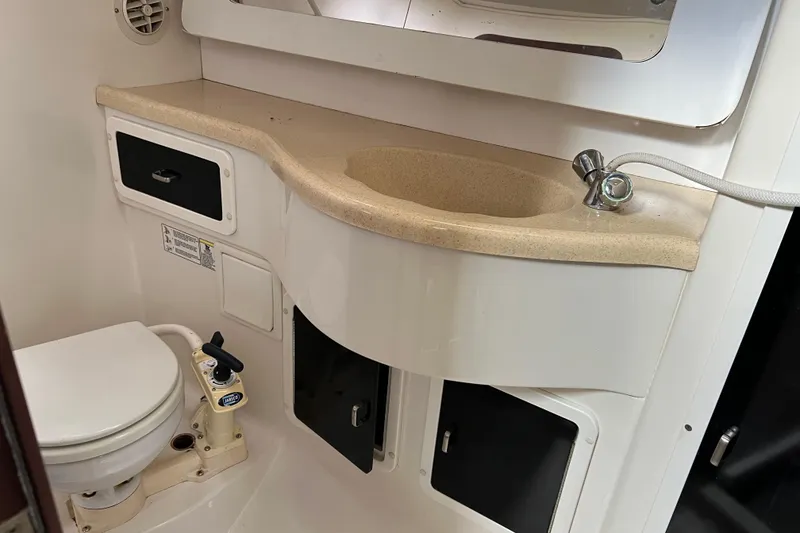 Slide: The Image of Bathroom interior of a 1997 Catalina 400 yacht, featuring a compact sink and toilet. - 24