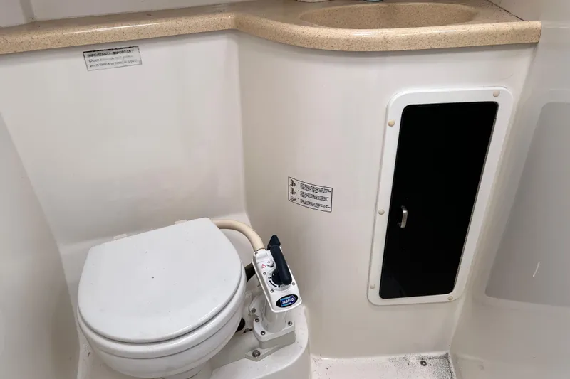 Slide: The Image of 1997 Catalina 400 yacht bathroom with marine toilet and storage compartment. - 25