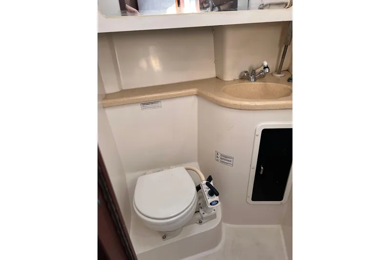 Slide: The Image of 1997 Catalina 400 yacht bathroom with toilet, sink, and storage cabinet. - 27