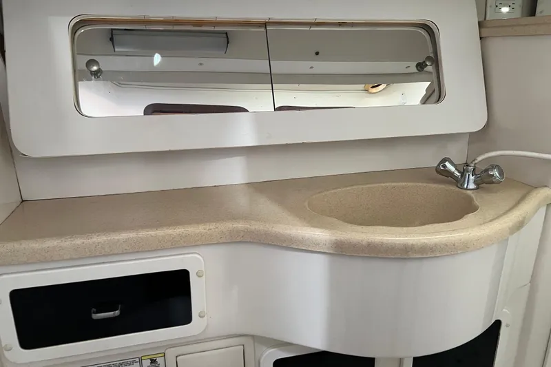 Slide: The Image of Bathroom sink area in a 1997 Catalina 400 yacht, featuring a mirror and faucet. - 28
