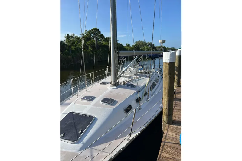 Slide: The Image of 1997 Catalina 400 sailboat docked, featuring sleek design and spacious deck. - 3