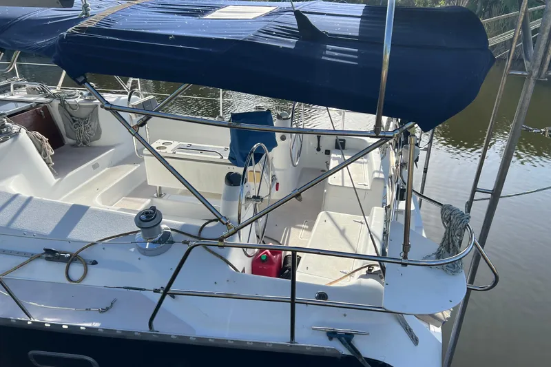 Slide: The Image of 1997 Catalina 400 sailboat cockpit with blue canopy and steering wheel. - 4
