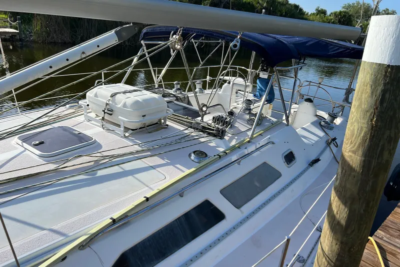 Slide: The Image of 1997 Catalina 400 sailboat docked, featuring deck equipment and rigging. - 6