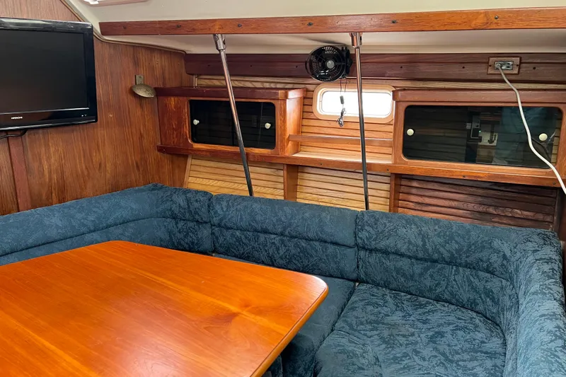 Slide: The Image of Interior of a 1997 Catalina 400 sailboat with wood accents and blue seating. - 8