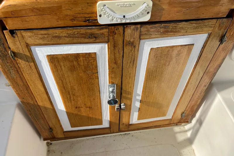 Slide: The Image of Wooden cabinet doors on a 1977 Gulfstar 43 boat, featuring a vintage design. - 8