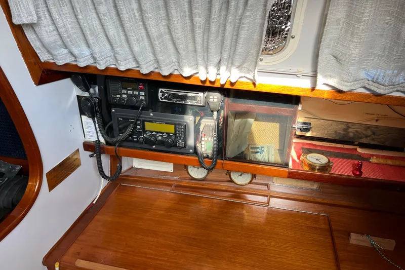 Slide: The Image of 1977 Gulfstar 43 yacht interior with navigation equipment and wooden cabinetry. - 9