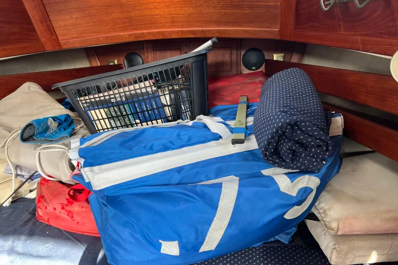 Slide: The Image of Interior of 1989 Pacific Seacraft Dana 24 with sailing gear and storage items. - 11