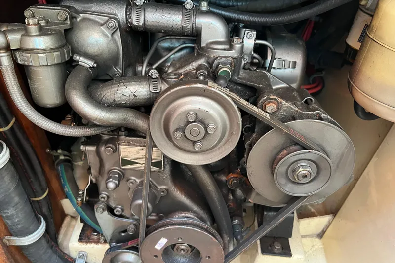 Slide: The Image of Engine of a 1989 Pacific Seacraft Dana 24 sailboat, showcasing belts and components. - 13