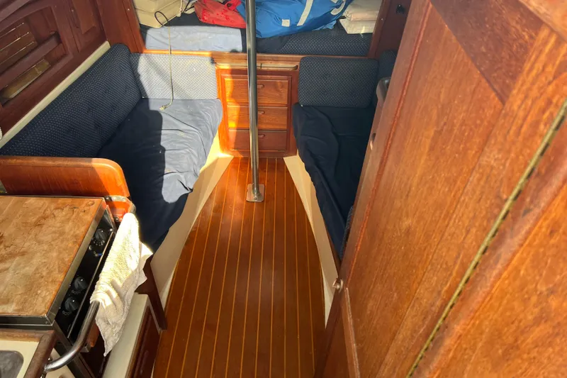 Slide: The Image of Interior of 1989 Pacific Seacraft Dana 24 sailboat with wooden flooring and cozy seating. - 6