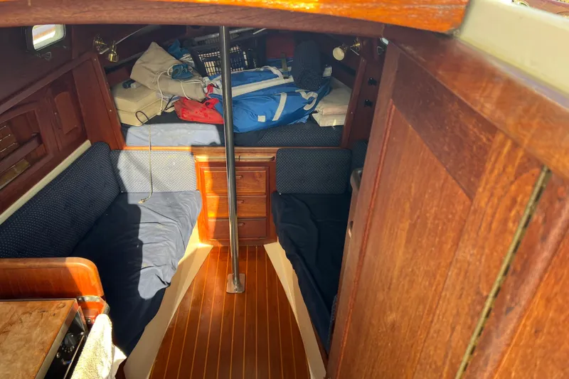 Slide: The Image of Interior of 1989 Pacific Seacraft Dana 24 sailboat with wooden finish and cozy seating. - 7