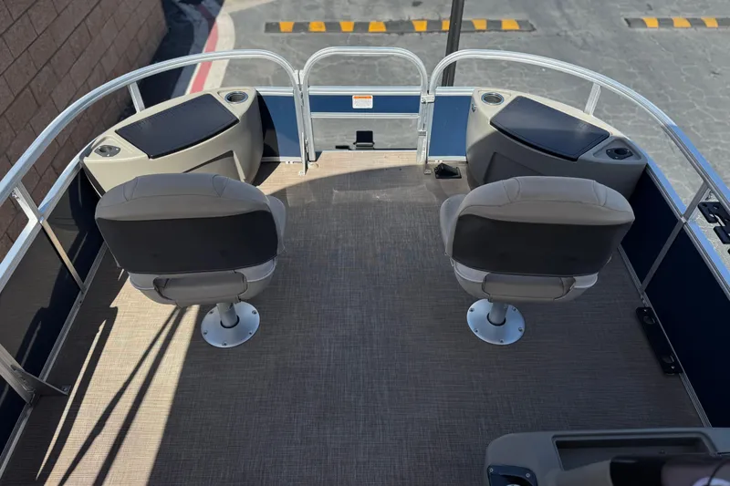 Slide: The Image of 2024 Sun Tracker Bass Buggy 18 DLX pontoon boat interior with two swivel seats. - 10